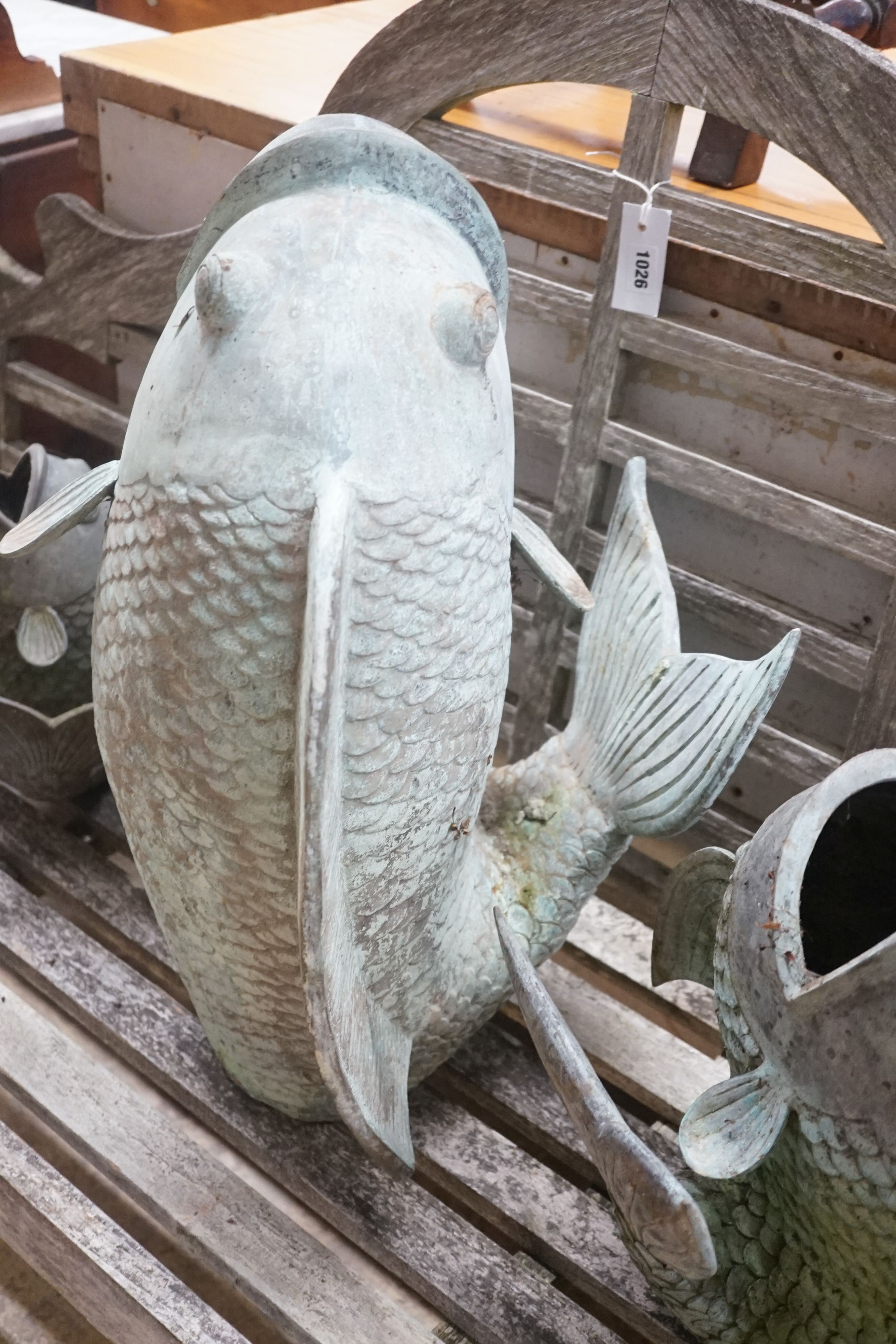 Three cast metal carp garden ornaments, largest 60cm height 46cm